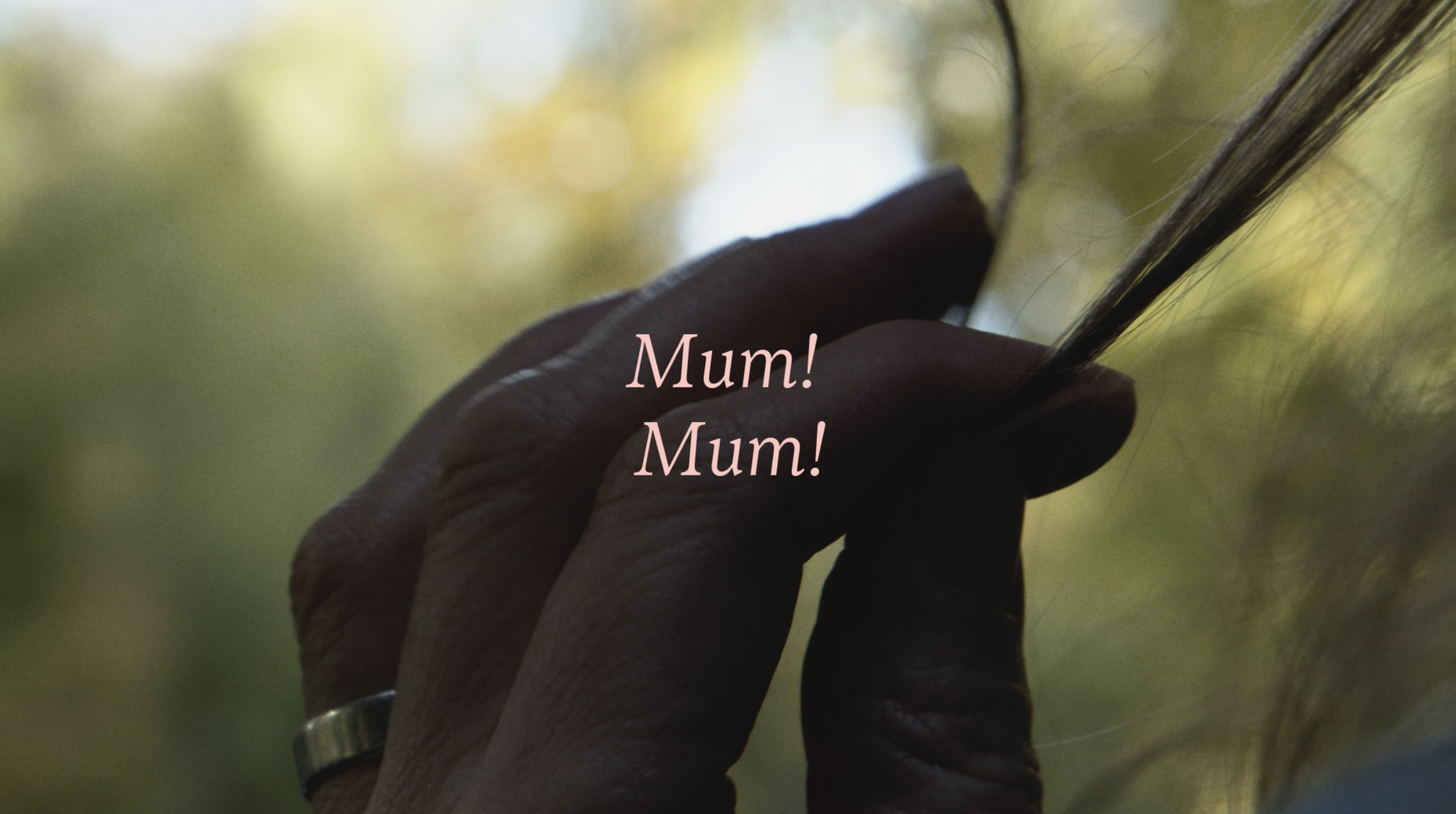 Image shows a hand twisting hair in it's fingers with blurry trees behind it. Over the image the words Mum! Mum! are written in pink.